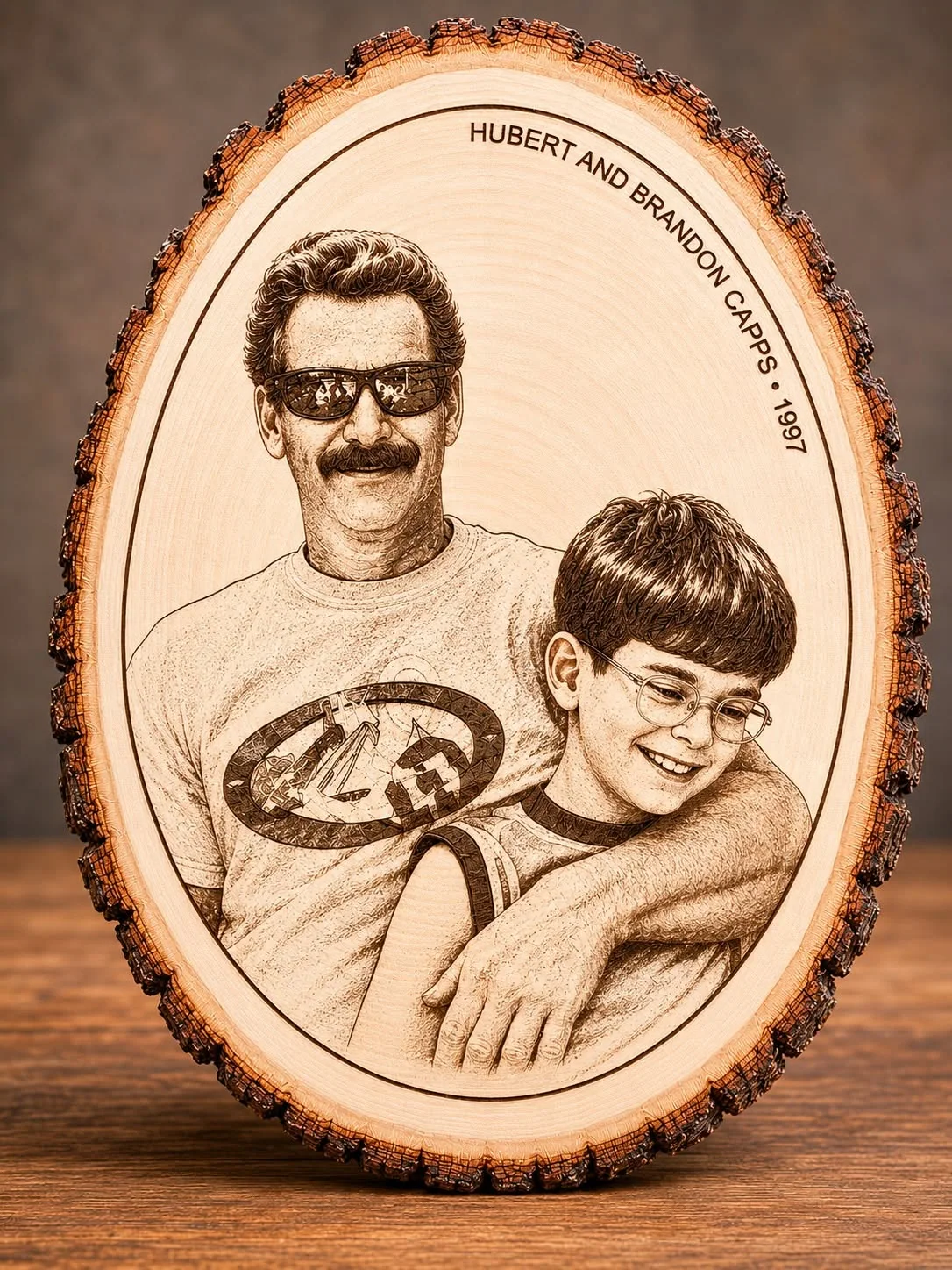 Engraved father and son portrait on oval natural wood slice